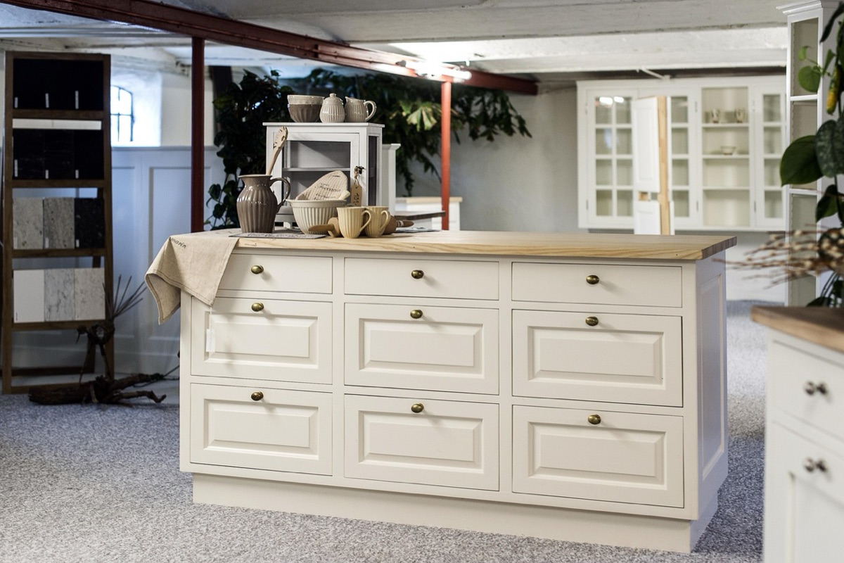 Clear acrylic organizers in a white kitchen cabinet